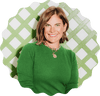 Mckinsey wearing a green sweater with a decorative green and white lattice background